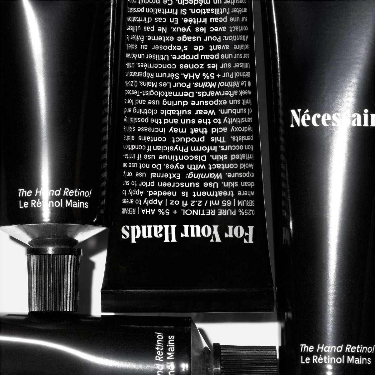 Nécessaire hand retinol ingredient callout highlighting retinol and AHA benefits