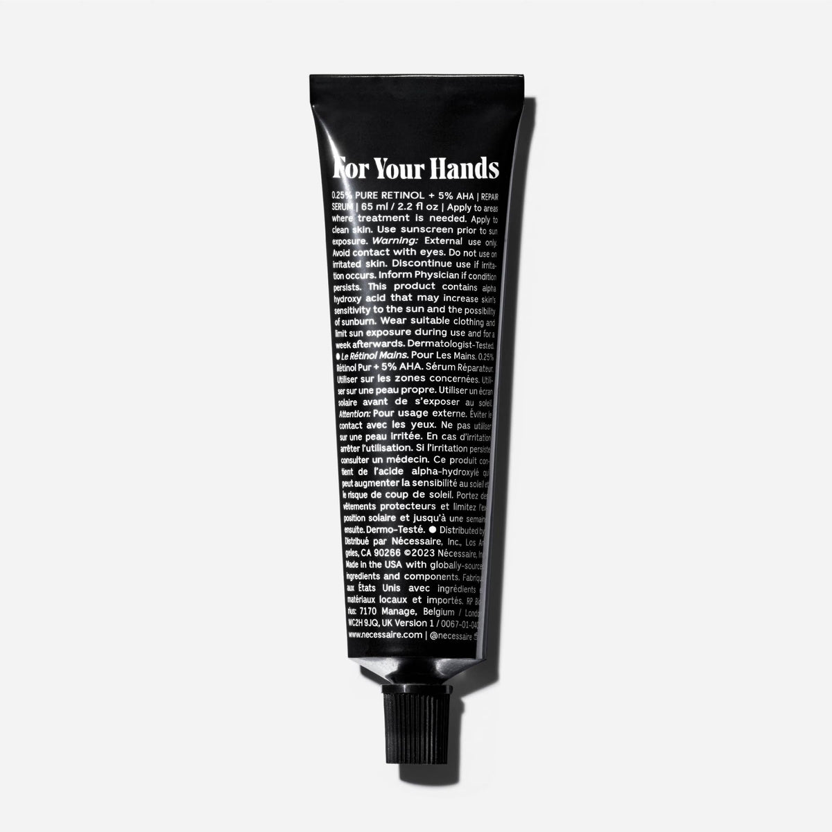 Nécessaire hand retinol open cap with balm texture demonstrating spreadability