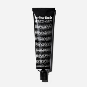 Nécessaire hand retinol open cap with balm texture demonstrating spreadability