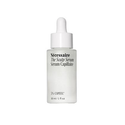 Nécessaire scalp serum front packaging showing the recyclable glass bottle and product name, communicates clean care