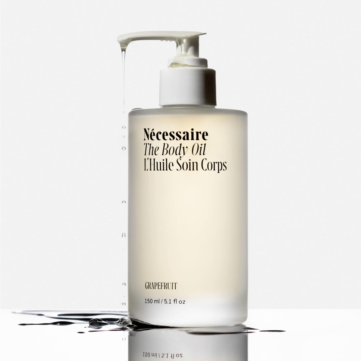 Nécessaire oil being poured from bottle highlighting smooth pour and control