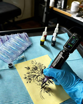 Neebol pen held in hand to show scale and comfortable handling during sessions