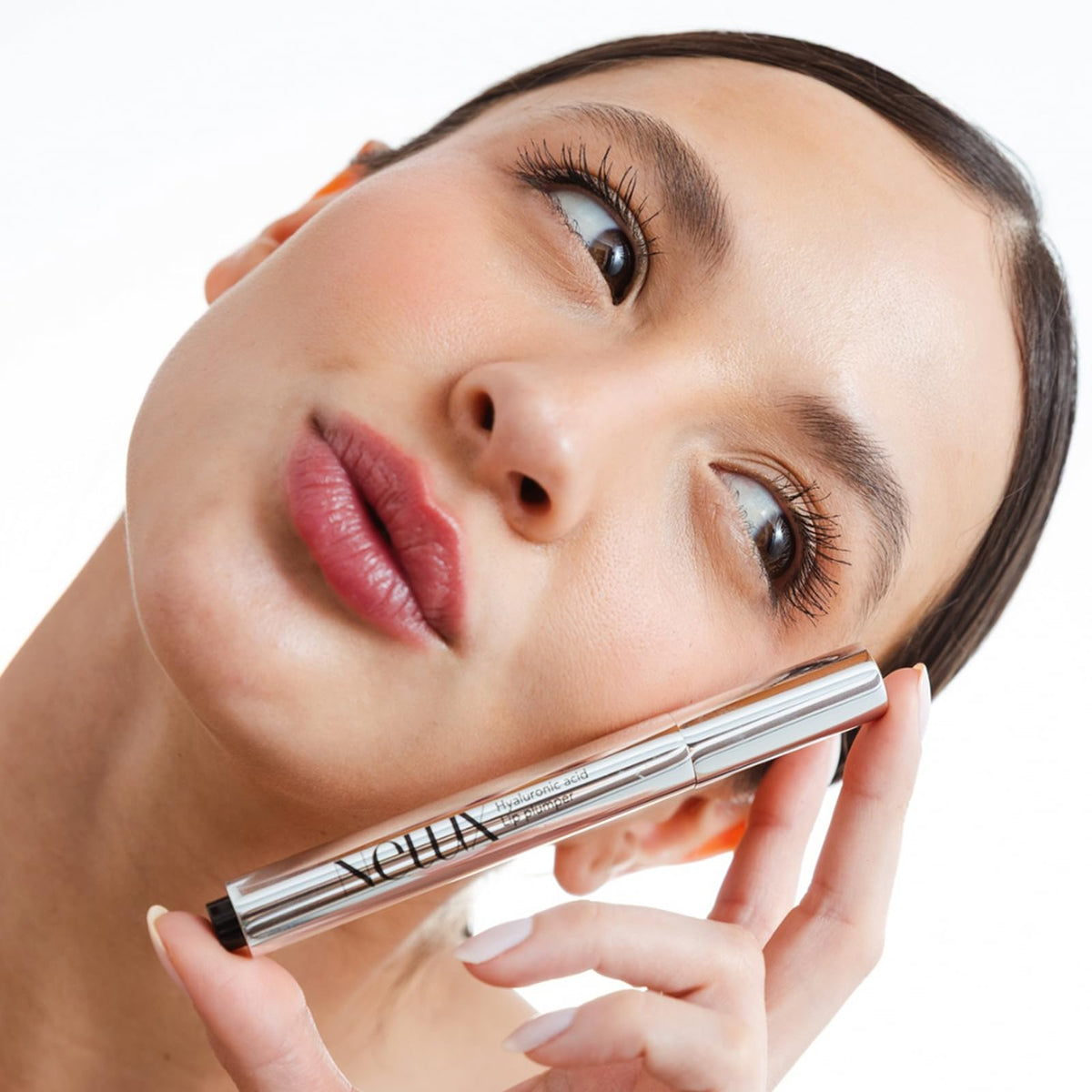 Nelux lifestyle model wearing clear gloss for natural plump benefit