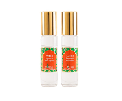 Nemat International front packaging showing two amber roll-on bottles and elegant glass