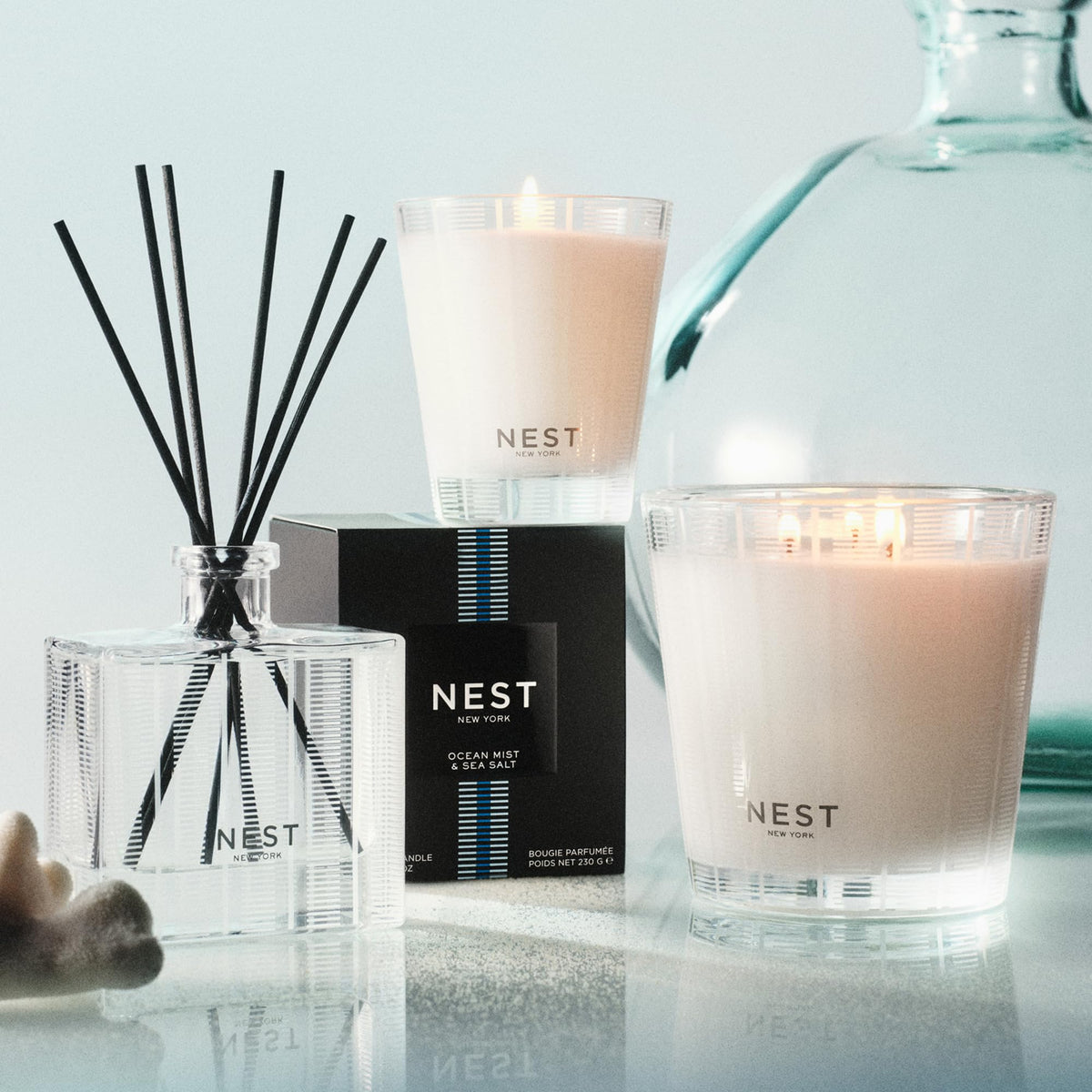 NEST New York bottle beside a hand for size comparison and lasting pumps benefit