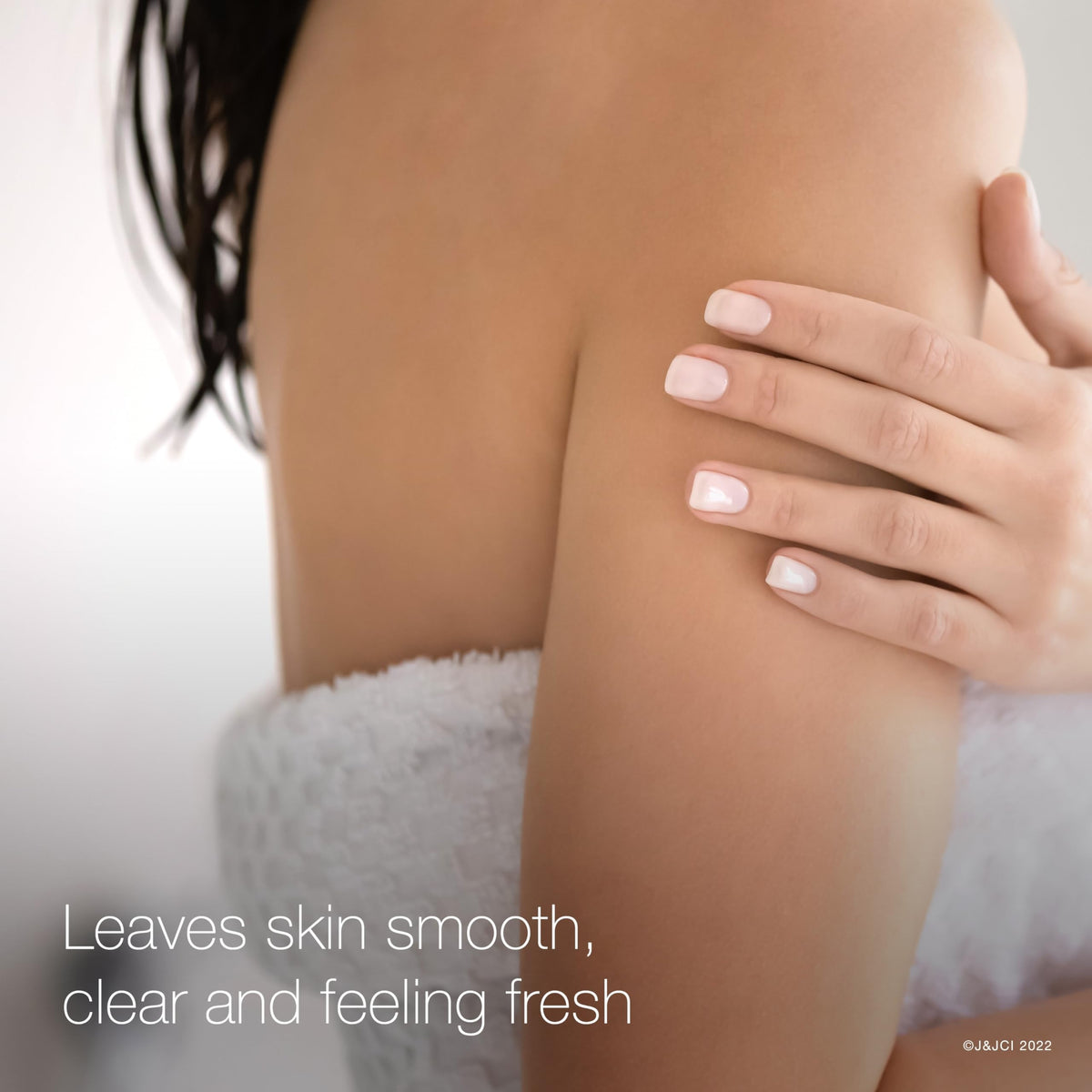 Neutrogena applying scrub to back to treat chest and shoulder acne