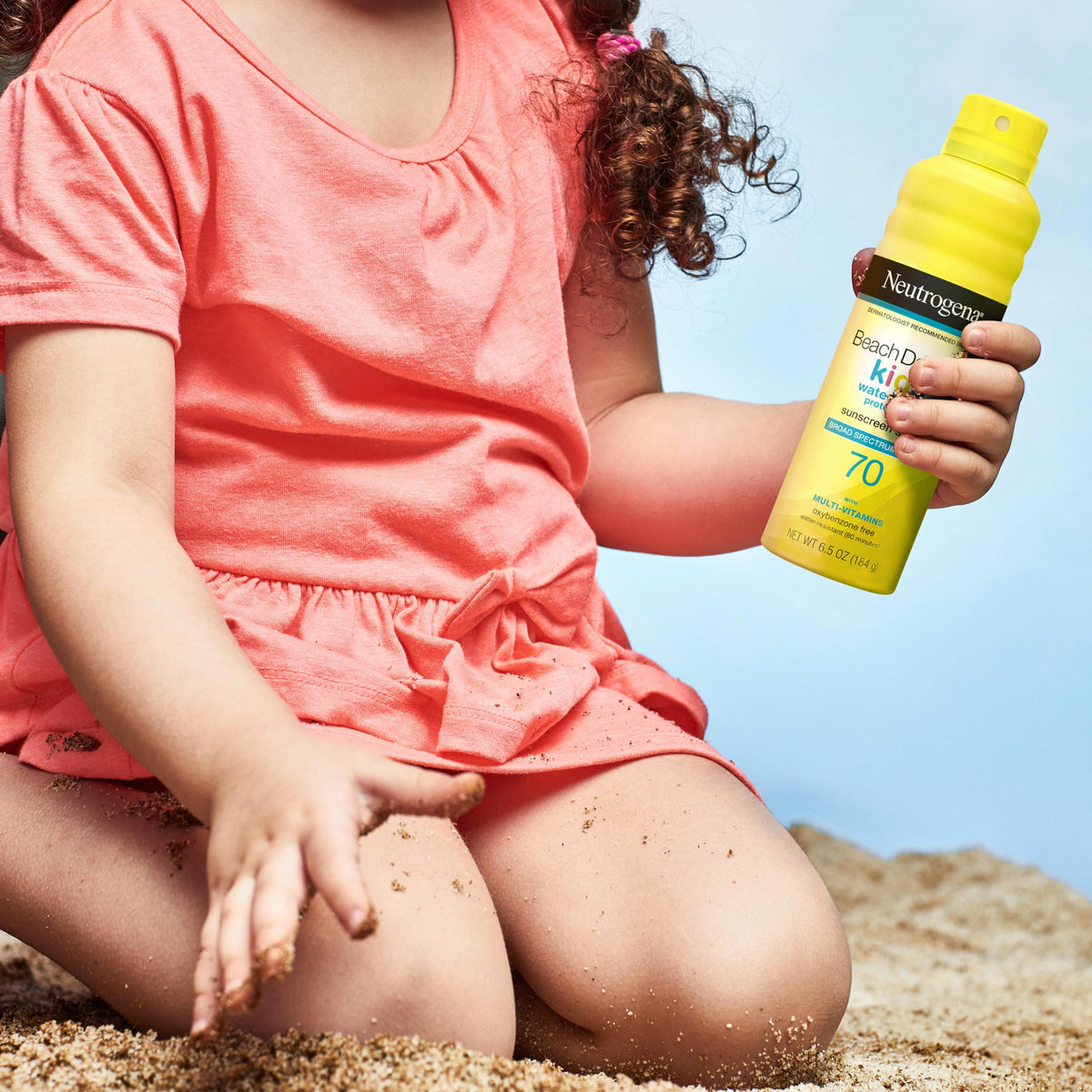 Neutrogena Beach Defense size comparison with water bottle for travel-friendly portability