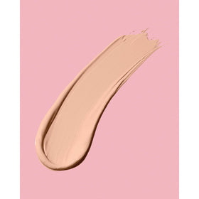 Neutrogena Brulee next to a coin shows compact travel-friendly size