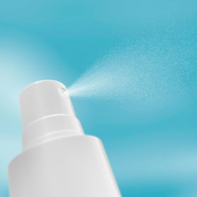 Neutrogena bottle held in hand for scale to show compact, travel-friendly size