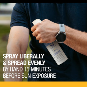 Neutrogena being sprayed on athlete shoulder for sweat-resistant protection