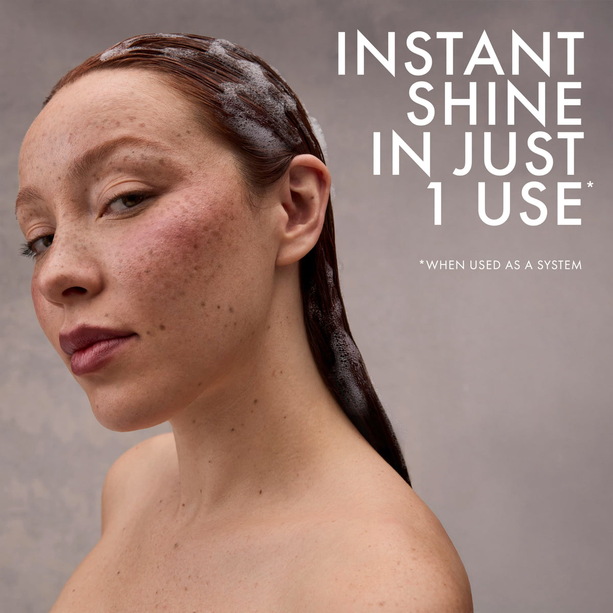 Nexxus shampoo being rinsed in shower illustrating color-safe cleansing