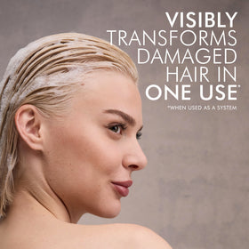 Nexxus KERAPHIX shampoo in shower being applied to wet hair for deep repair
