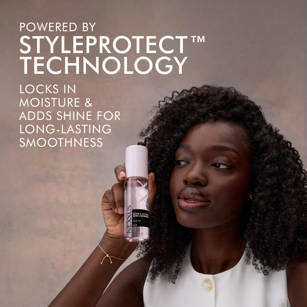 Nexxus oil texture on fingertips showing lightweight absorbent finish