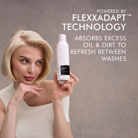 Nexxus can held in hand to show 5 oz size and travel-friendly benefit