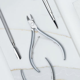 Nghia cuticle nipper size comparison with ruler to show scale and portability