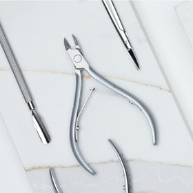 Nghia cuticle nipper beside ruler showing compact size and travel-friendly scale