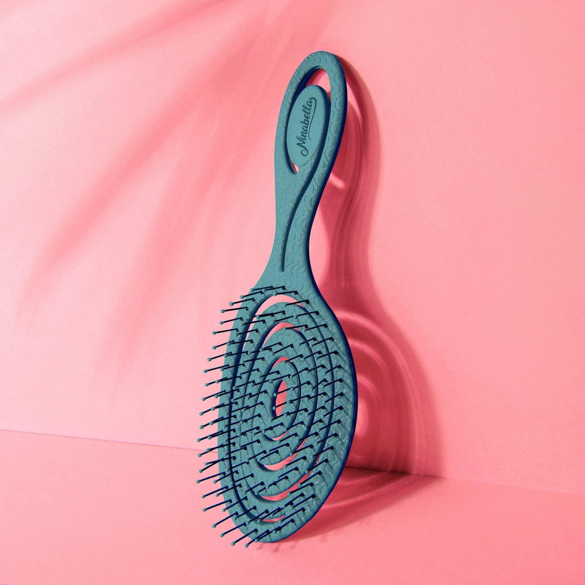 Scale comparison of Ninabella brush held to show size and easy portability benefit