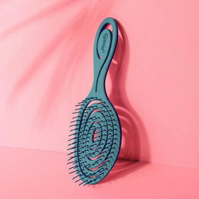 Scale comparison of Ninabella brush held to show size and easy portability benefit