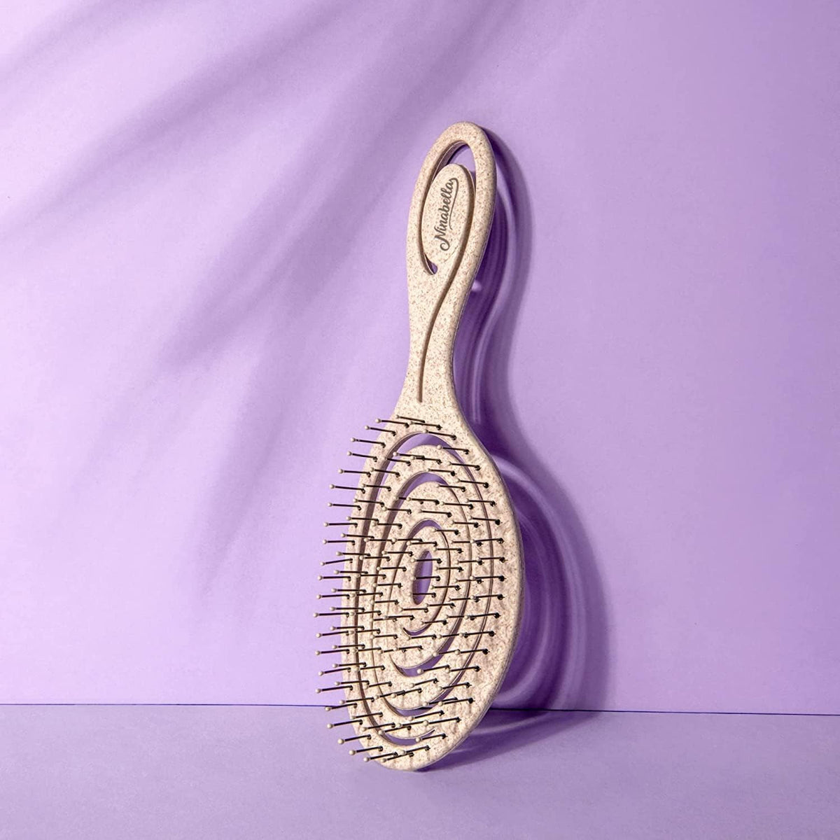 Ninabella brush in use on wet hair demonstrating pain-free detangling benefit
