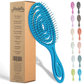 Ninabella front view of ocean blue detangling brush showing shape and finish