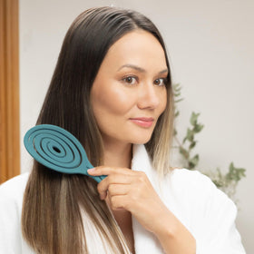 Lifestyle image of Ninabella detangler smoothing curly hair for reduced knots and frizz