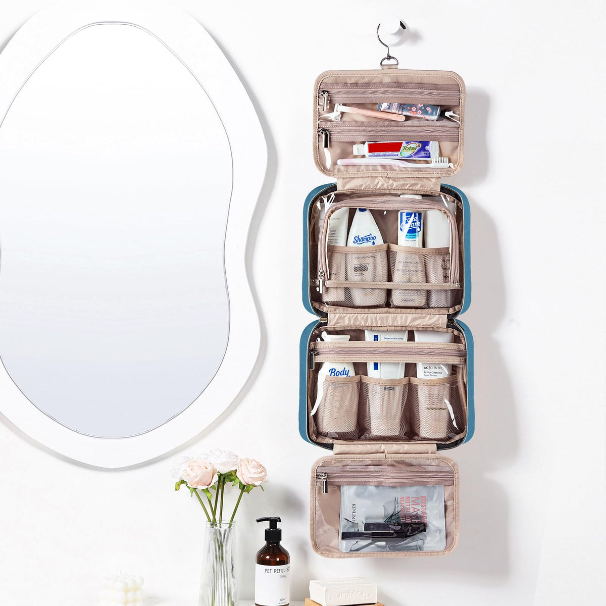 NISHEL open flat interior displaying organized compartments and full-sized bottles