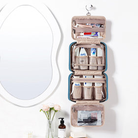 NISHEL open flat interior displaying organized compartments and full-sized bottles