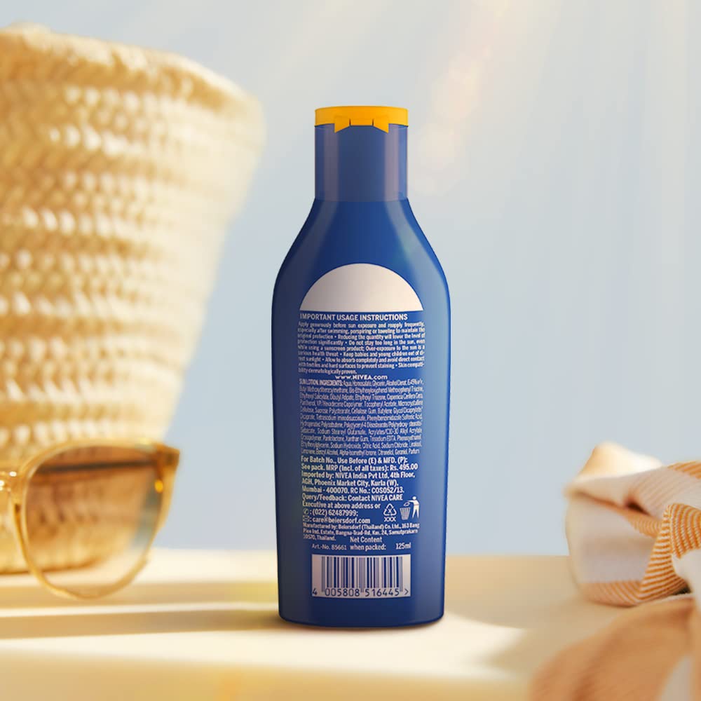 Person applying NIVEA on shoulders at beach for travel convenience