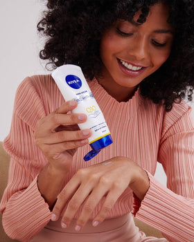 NIVEA tube beside everyday items showing 100 ml scale and portability advantage