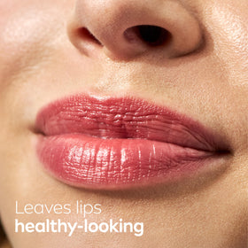 Applying NIVEA lip balm in hand lifestyle shot showing instant lip hydration