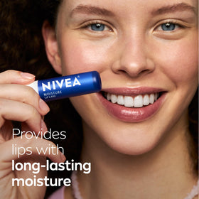 NIVEA lip balm stick held in hand to show compact size and portability