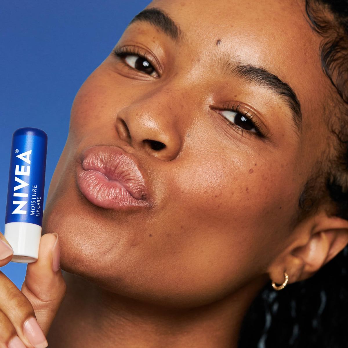 NIVEA lip balm placed inside a purse showing travel-ready convenience