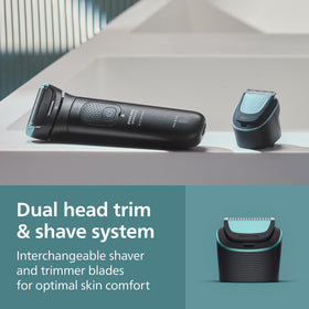 Norelco ergonomic grip held in hand for secure control when trimming hard‑to‑reach areas