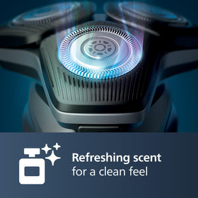 Norelco cartridge in use inside cleaning pod removing hairs and protecting blades
