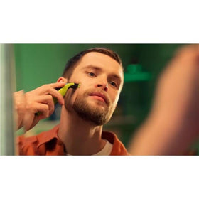 Norelco OneBlade 5-in-1 adjustable comb detail showing length settings and anti-clog design