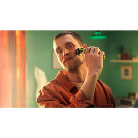 Norelco OneBlade held in hand to show scale and travel-friendly size benefit