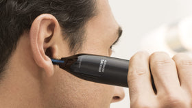 Norelco trimmer on bathroom counter showing everyday grooming setup