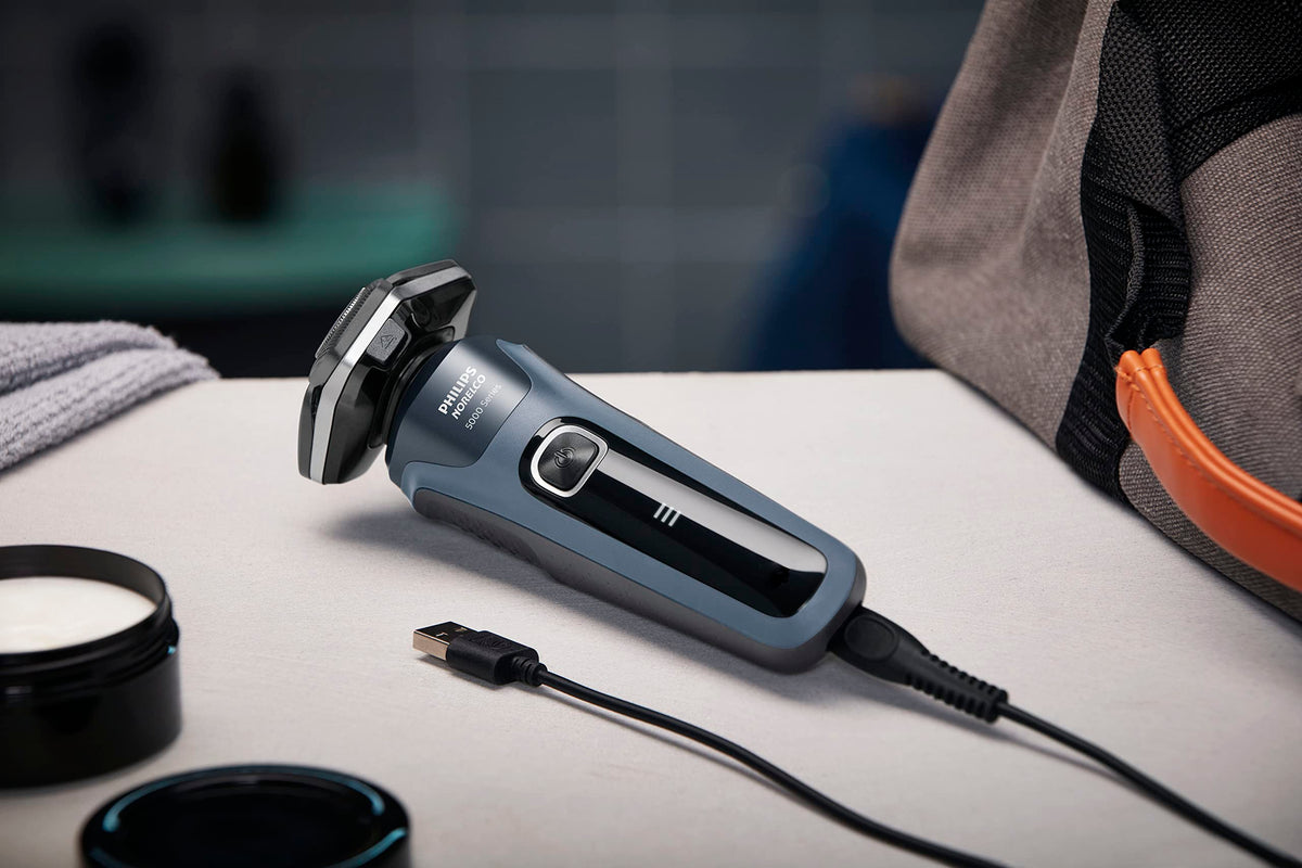 Norelco shaver 5400 with USB-A cable and packaging showing included accessories and ready-to-charge benefit