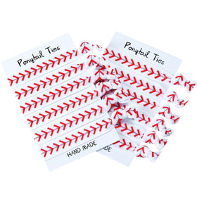 Norme front-packaging showing 12 white baseball hair ties and organized set benefit