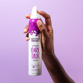 Not Your Mother's products being applied to damp hair demonstrating styling method