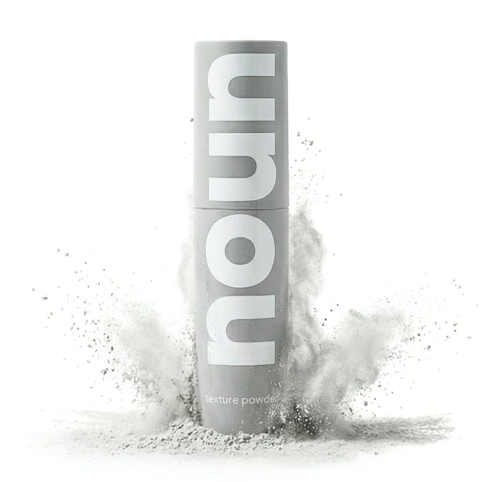 NOUN front bottle shot showing powder-spray design and clean formula benefits