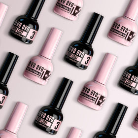 Hands applying press‑on French tip using NOVO OVO kit for precise easy placement