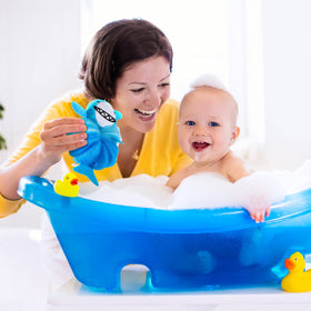 Child using Nuenen loofah in bath, illustrating playful design that encourages washing