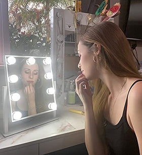 NUSVAN mirror beside hand for scale to show compact, portable size