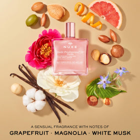NUXE bottle in hand showing 1.6 fl oz scale and travel-friendly size