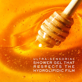NUXE bottle by bathtub in warm setting suggesting relaxing, hydrating shower
