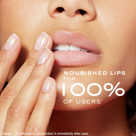 Nuxe lip balm in hand for size comparison and travel-friendly benefit