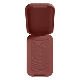 NYX PROFESSIONAL MAKEUP Buttermelt Bronzer swatch close-up on medium-deep skin showing rich warm red pigment
