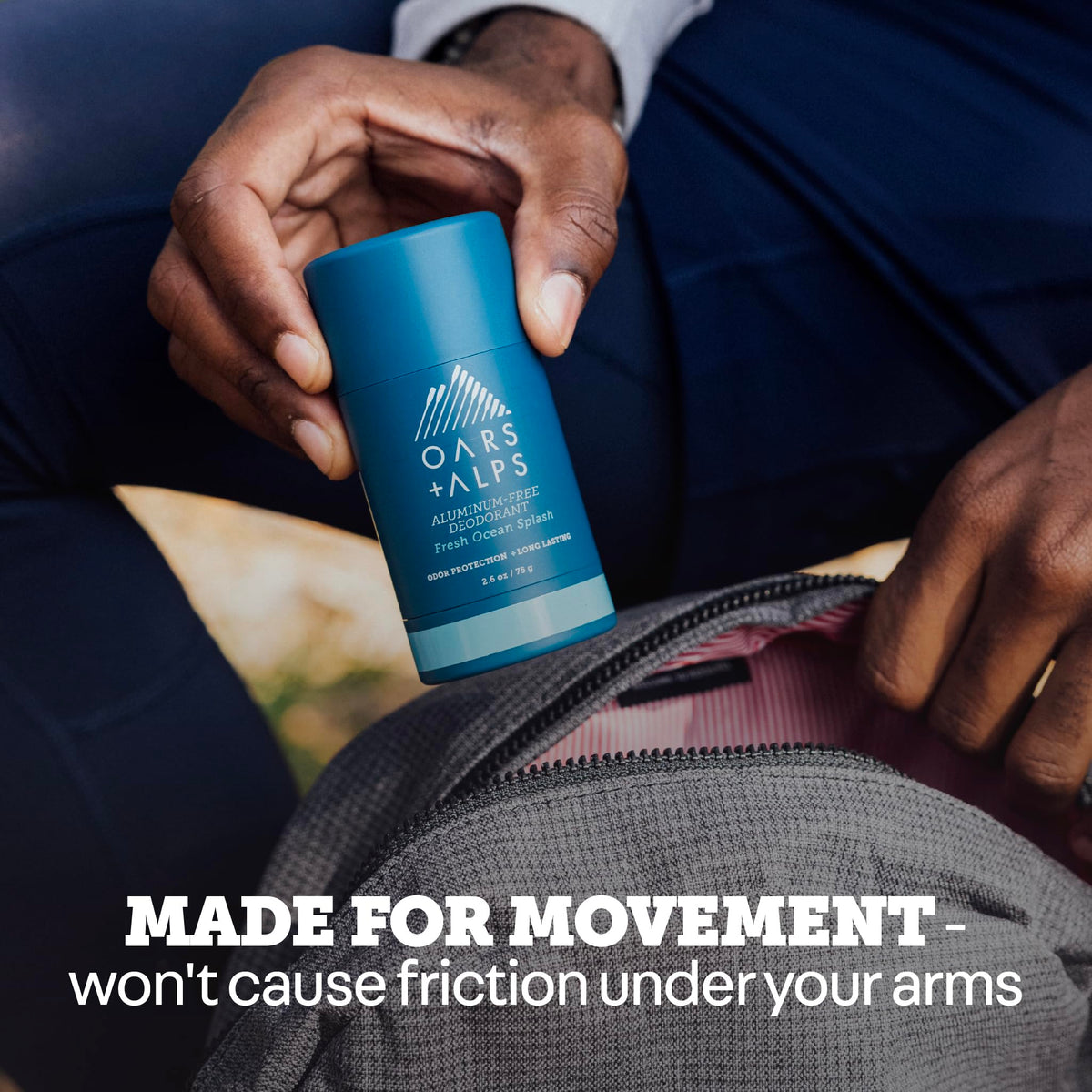 Oars + Alps applying deodorant to underarm demonstrating non-sticky quick-dry benefit