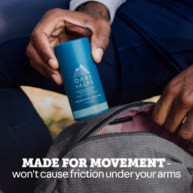 Oars + Alps applying deodorant to underarm demonstrating non-sticky quick-dry benefit